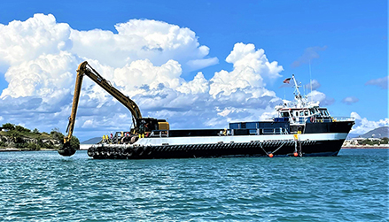 Dredging with clamshell bucket on excavator